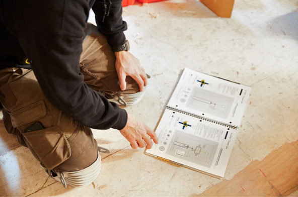 Plumber Reading a product manual
