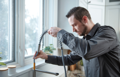 Plumber installing faucet
